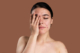 Woman with acne-prone skin considering professional Body Treatment Chevy Chase for clearer, healthier skin.