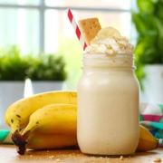 A mug of banana healthy milkshake showcasing why it should be mandatory in your daily diet plan