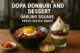 A close-up food photo featuring a bowl of donburi with glazed pork and a sunny-side-up egg on top, served alongside small dishes of kimchi and pickled ginger. Next to it is a layered dessert in a glass with matcha mousse, whipped cream, red bean paste, and a scoop of matcha ice cream, all set on a wooden table with a blurred restaurant background.