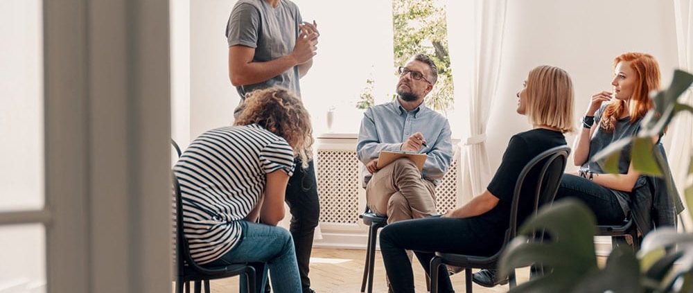 group-therapy-session-man-standing